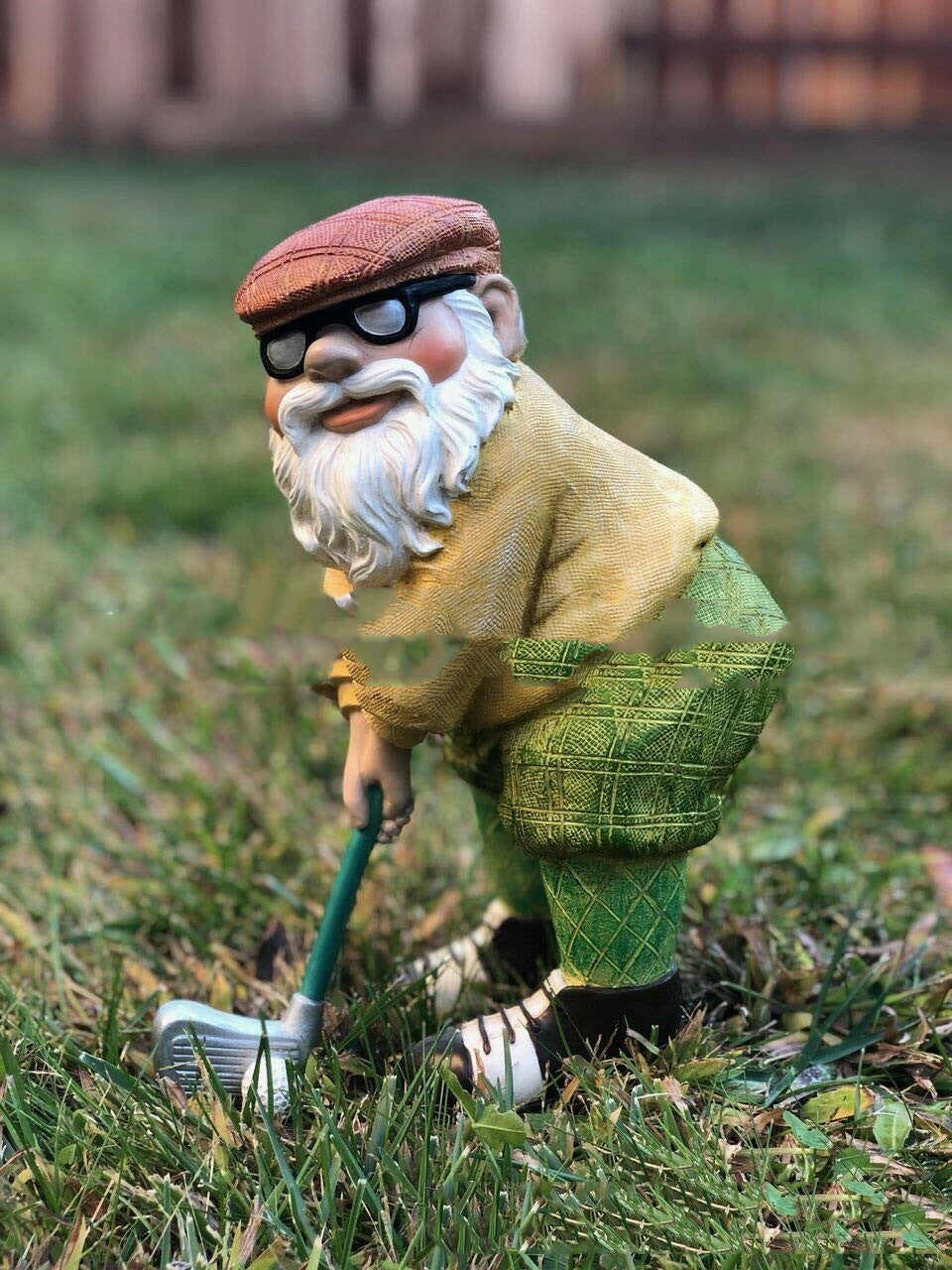The Garden Is Decorated With Statues Of Golfing Gnomes